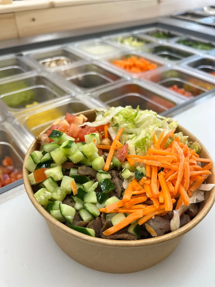 Bowl in front of the toppings bar