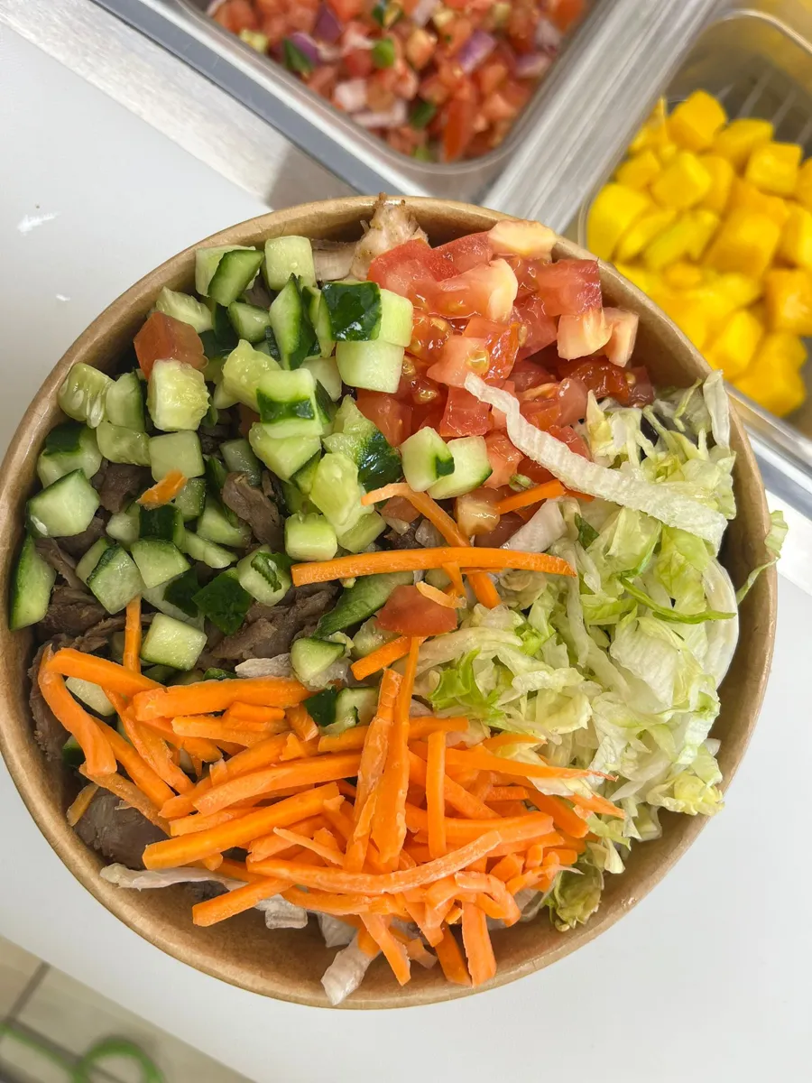 Bowl with cucumber, tomato, carrots and lettuce